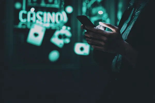 JUGABETT Casino Games — Enjoy nonstop entertainment A close-up shot of golden coins falling around a spinning roulette wheel, representing immersive casino action at JUGABETT.