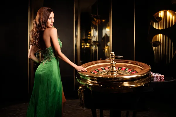 A person using their device against a moody casino-themed background, illustrating the smooth re-entry process at JUGABETT.